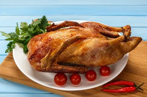Roast duck on a white platter. Ready to serve poultry. Table setting. Roasted 스톡 사진