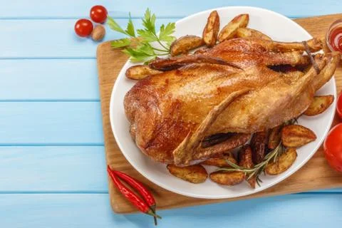 Roast duck on a white platter. Ready to serve poultry. Table setting. Roasted Stock Photos