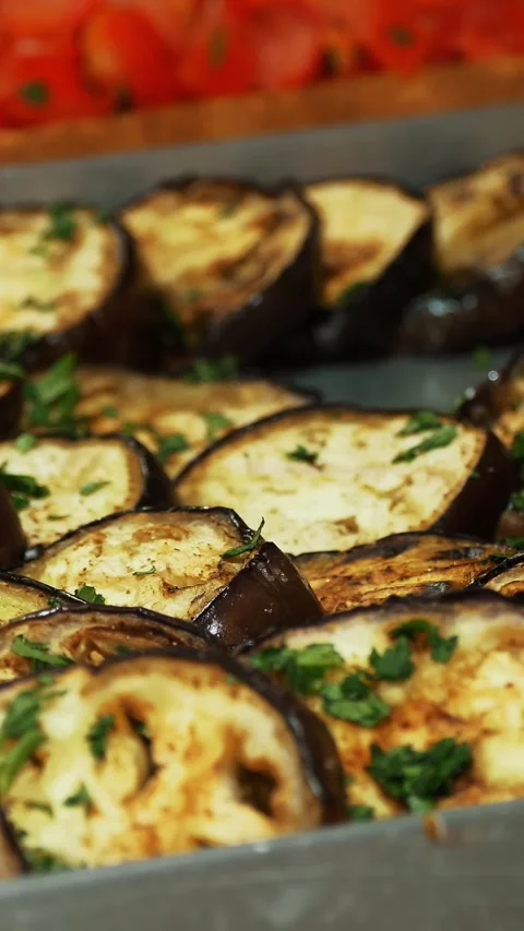 Roast eggplant with herbs. Close-up. Sliced fried eggplant pieces, rings. Stock Footage 315364585