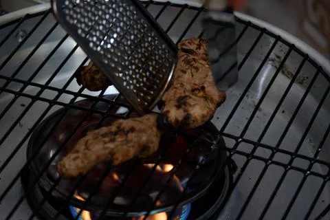 Roast the ginger before pounding it using a grill pan Stock Photos