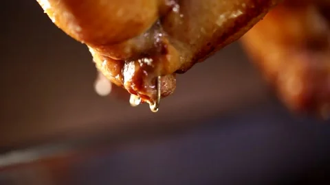 The roast goose in the fireplace drips appetizing soup, close-up shot3 Stock Footage 236530847