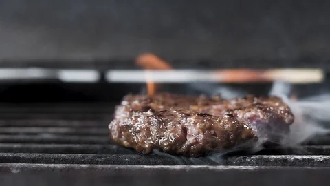 Roast the meat for the Burger flip on the grill.  slow motion, close-up. Stock Footage