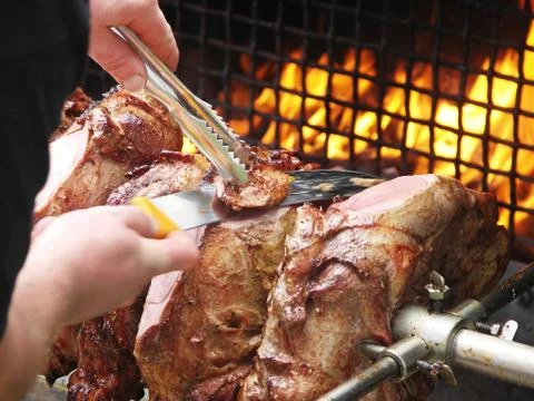 Roast meat by fire with flames, traditionally eaten at different family feast Foto stock