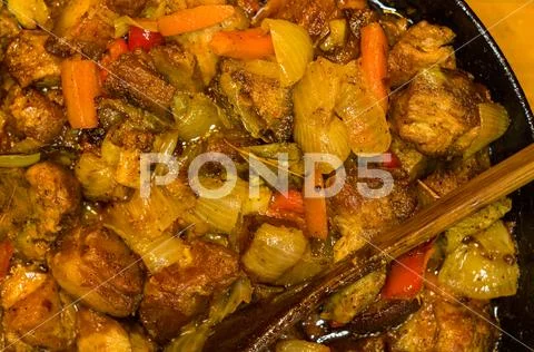 Roast meat, onions, carrots and spices, boiling in oil Stock Photos