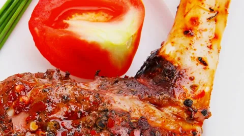 Roast meat shoulder on white with tomatoes Vídeos de archivo 30394074