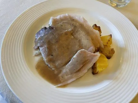 Roast pork with potatoes on the table. Stock Photos