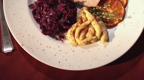 Roast pork with red cabbage, spaetzle noodles and sauce Stock Footage 8570569