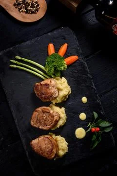 Roast pork steak with mashed potatoes on a plate from top view Stock Photos