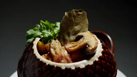 Roast in a pot, a dish of stewed ribs, with potatoes and mushrooms, presentation Stock Footage 153804702