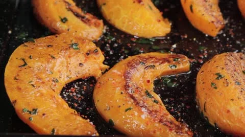 Roast pumpkin wedges on a baking tray Vídeos de archivo 24667486