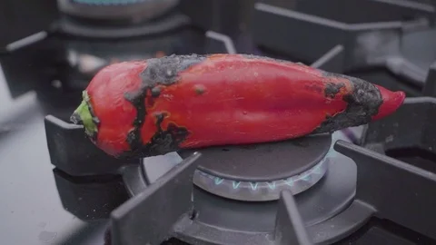 Roast Red Pepper On The Oven In The Kitchen. 4K Slow Motion. Video stock 97698551