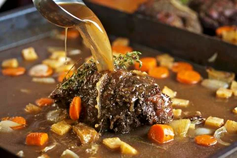 Roast venison with root vegetables in a pan Stock-Fotos