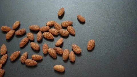Roasted almonds with hand picking Video stock 104234849
