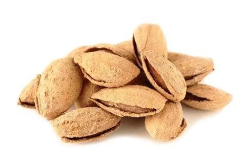 Roasted and salted almonds in shell on a white background Stockfoto's