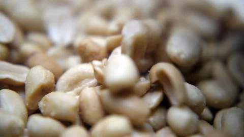Roasted and salted peanuts falling in slow motion Video stock 168909898