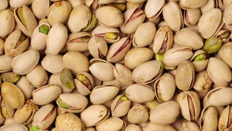 Roasted and salted pistachios background moving slowly Stock Footage 320954638
