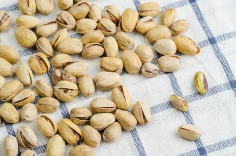 Roasted and salted pistachios on table cloth.. Stock Photos