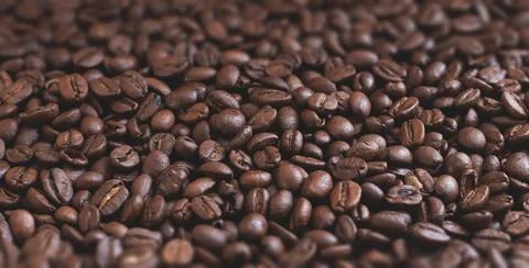 Roasted aromatic coffee beans as background Stock Photos