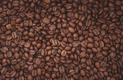 Roasted aromatic coffee beans as background Stock Photos