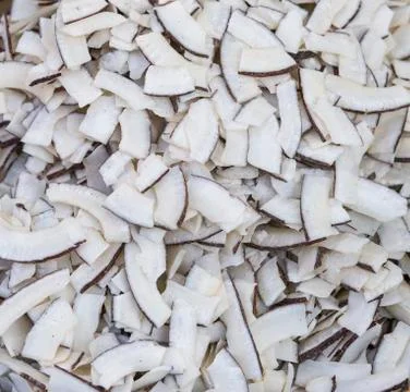 Roasted baked toasted Natural Thin Sliced Coconut Chips Background texture Stock Photos