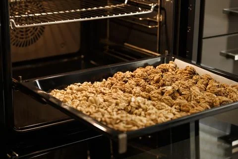 Roasted baked walnuts close up on a baking sheet Stock Photos