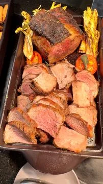 Roasted beef are elegantly displayed in cast iron pans, capturing timeless Stock Photos