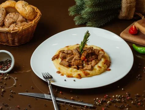 Roasted beef pieces with mashed potato puree Stock Photos