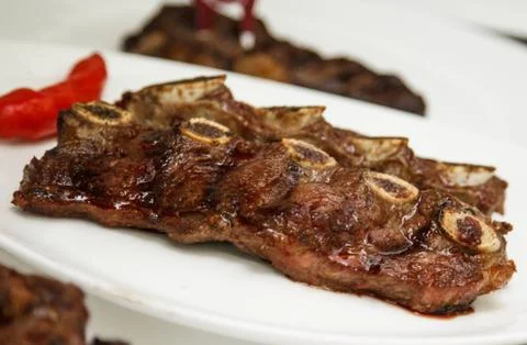 Roasted beef rib served on a white plate Stock Photos