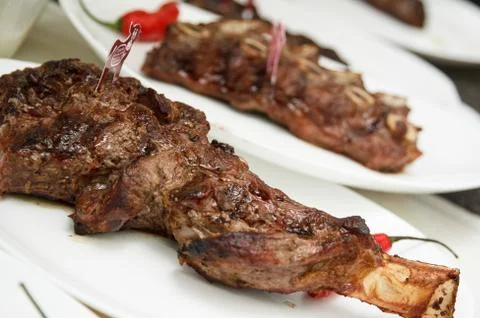 Roasted beef rib served on a white plate Stock Photos