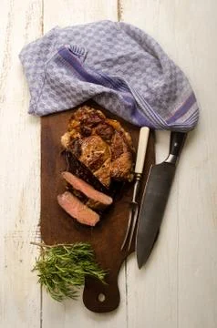 Roasted beef shoulder with meat fork and knife Stock Photos