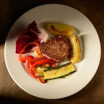 Roasted beef steak with vegetable decorated and searved on a plate Stock Photos