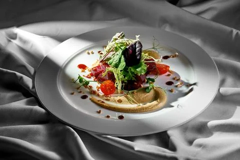 Roasted beetroot and pine nut salad in a plate. Vegetarian food Stock Photos