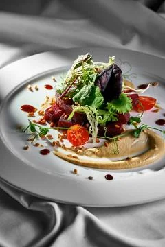 Roasted beetroot and pine nut salad in a plate. Vegetarian food Stock Photos