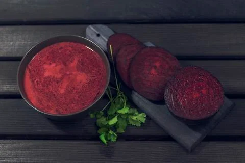 Roasted beetroot soup on a dark background. Baked beets soup. Christmas dish. Stock Photos