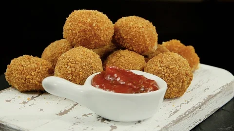 Roasted breaded mozzarella cheese balls tomato sauce rotation 360 degrees Stock Footage 127786555
