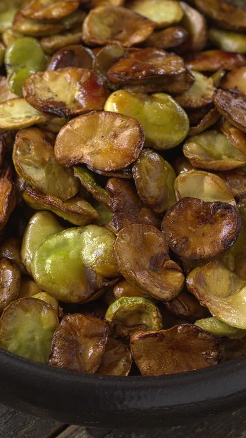 Roasted broad beans in a bowl. Vertical video. Video stock 313835260