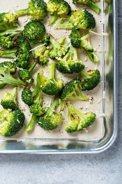 Roasted broccoli on a baking tray Stock Photos