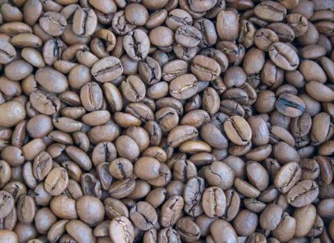 Roasted brown coffee beans close up background Stock Photos
