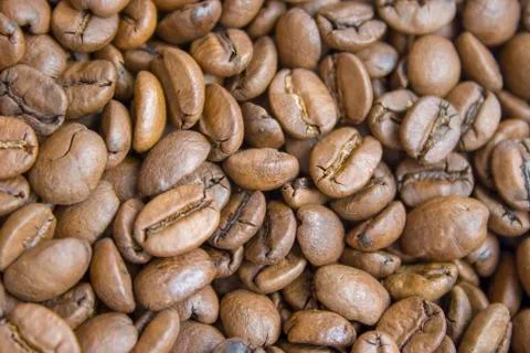 Roasted brown coffee beans close up background Stock Photos