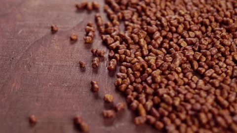 Roasted buckwheat tea grains on a dark brown rustic wooden board surface. Mac Stock Footage 166459576