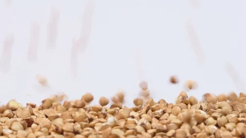 Roasted buckwheat on white background falling from top and filling up frame. Stock Footage 108054422