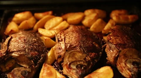 Roasted carp with potatoes in the oven Stock Footage 68193840