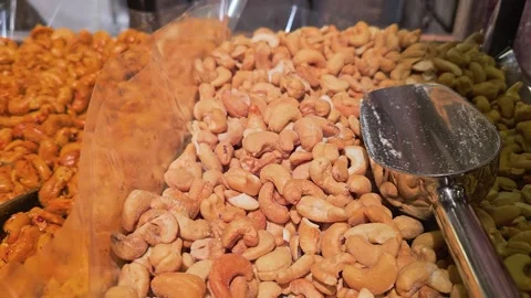Roasted cashew and mixed nut display in a specialty food market, with stainless Stock Footage 340866824