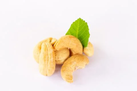 Roasted Cashew nuts with leaf isolated on white background with clipping path Stock Photos