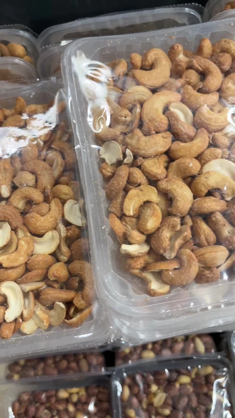 Roasted Cashew Nuts in Plastic Containers Close Up Snack Background Stock Footage 331073708
