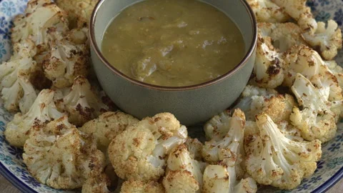 Roasted cauliflower served with tomatillo salsa. Stock Footage 277539100