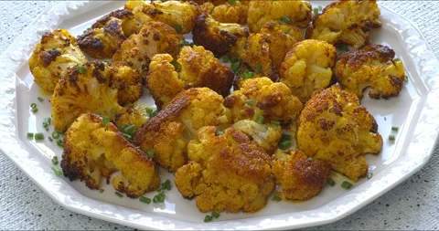 Roasted cauliflower with turmeric on a serving plate. Stock Footage 310144446