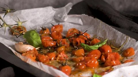 Roasted cherry tomatoes with garlic and basil Stock Photos