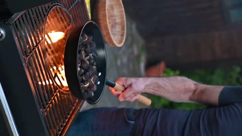 Roasted chestnuts and maroni over the fire in a special steel pan. Traditional Video stock 166507294