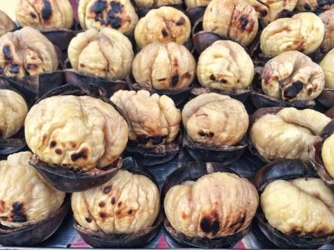 Roasted chestnuts as a background Stock Photos